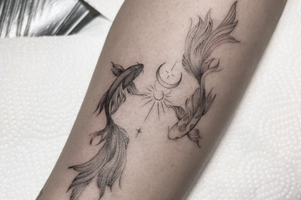 Yin–yang koi tattoo in fine-line shading, created at Good Times Ink Osaka.