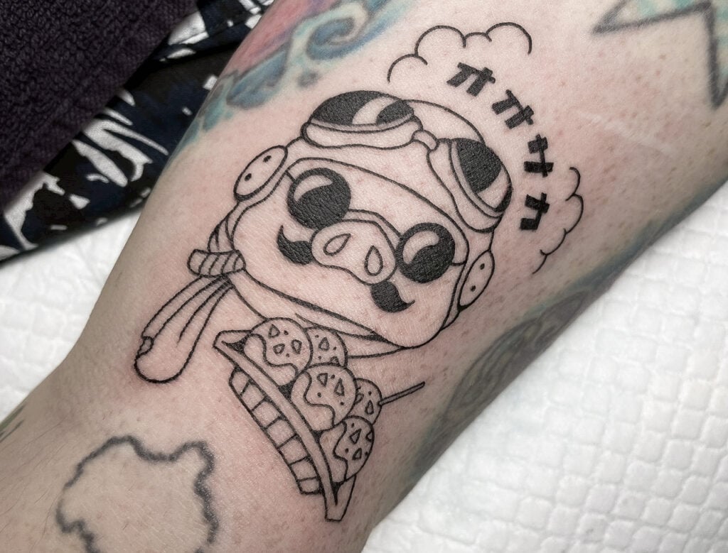 Porco Rosso minimal pilot tattoo with goggles and scarf, Osaka.