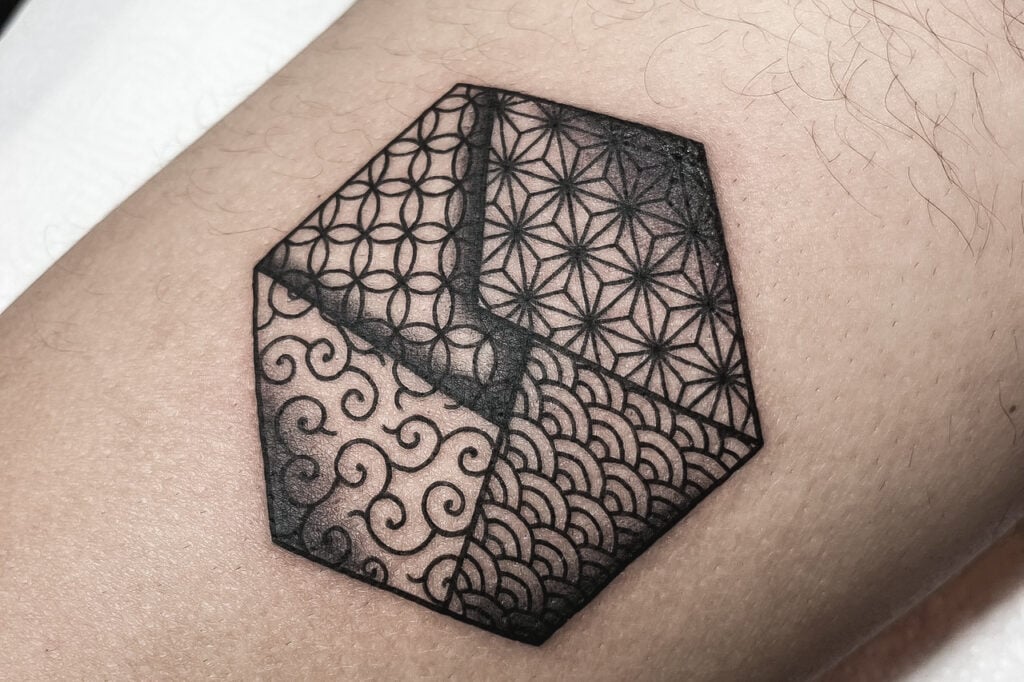 Blackwork Japanese pattern tattoo featuring multiple traditional motifs, created at Good Times Ink Osaka.