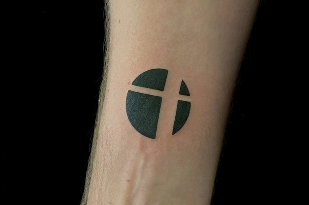 Minimal black silhouette Smash Ball tattoo from Super Smash Bros., created at Good Times Ink Osaka.