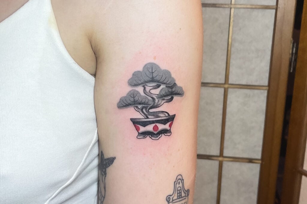 Stylized bonsai tattoo with patterned pot, created at Good Times Ink Osaka.