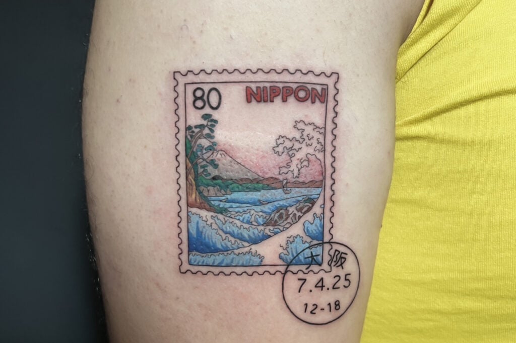 Color stamp-style tattoo inspired by Japanese scenery, created at Good Times Ink Osaka.