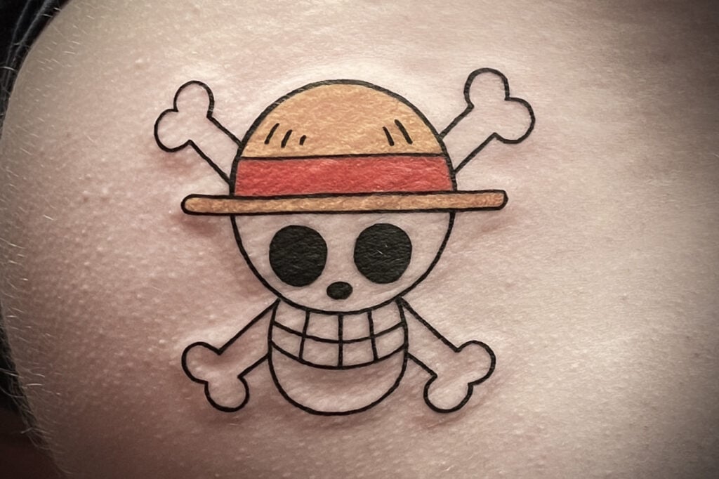 One Piece Jolly Roger emblem tattoo shown as a crisp symbol.