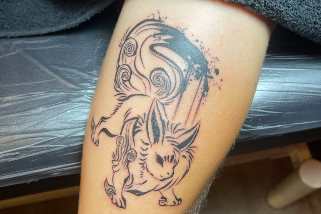Japanese brush-style Jolteon tattoo with swirling ink patterns and bold black strokes, created at Good Times Ink Osaka.