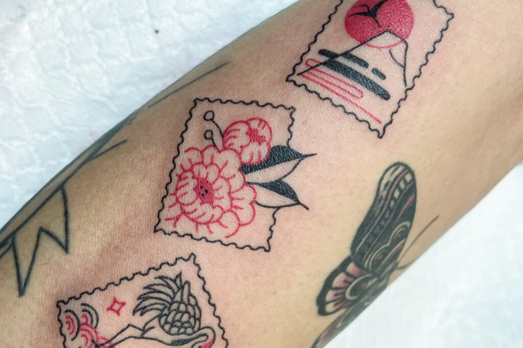 Small stamp-style tattoos with Japanese floral and Mount Fuji motifs, created at Good Times Ink Osaka.