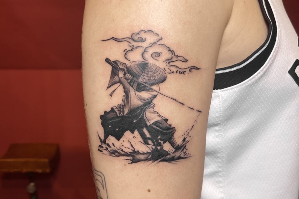 Samurai tattoo with dramatic motion and cloud motif, created at Good Times Ink Osaka.