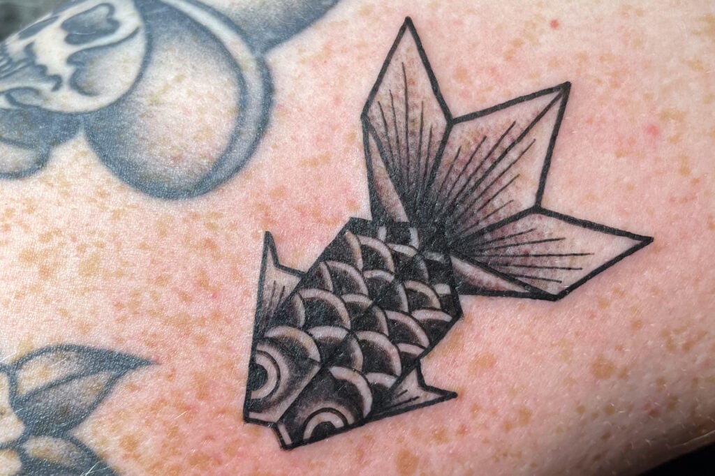 Origami-style goldfish tattoo from Horihina’s flash collection, created at Good Times Ink Osaka.