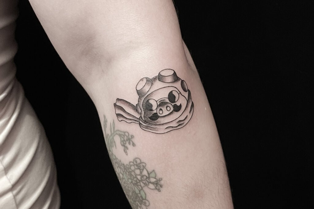 Porco Rosso minimal pilot tattoo with goggles and scarf, Osaka.