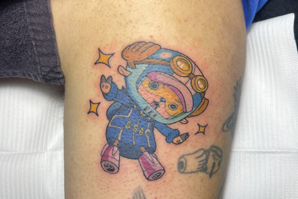 Chopper motif tattoo emphasizing friendly round features, Osaka.