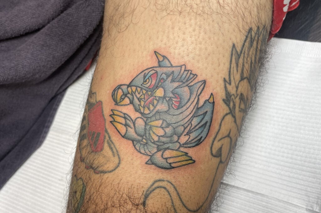 Blue‑Eyes Ultimate Dragon tattoo in friendly toon‑style, Osaka.