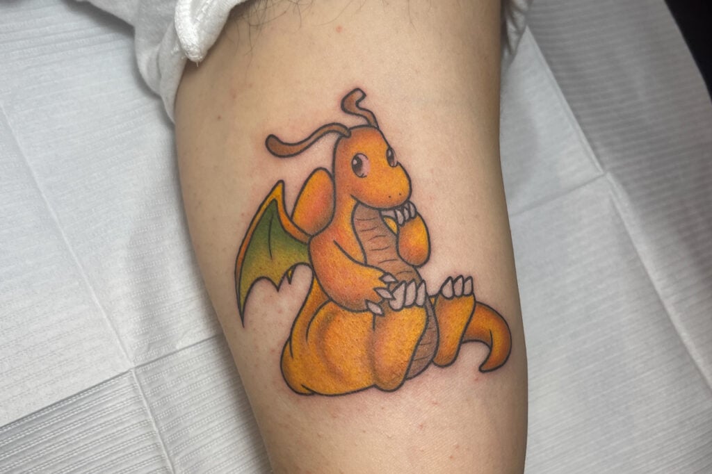Soft color Dragonite tattoo with warm shading and a friendly expression, created at Good Times Ink Osaka.