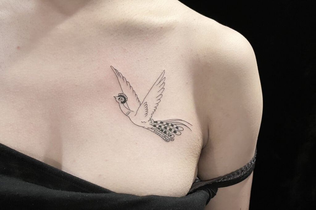 Tezuka Phoenix tattoo with graceful, flowing outline, Osaka.