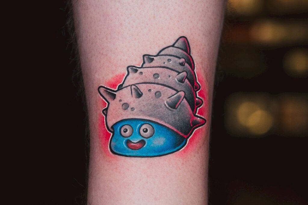 Marine Slime tattoo with bold blue coloring and ESTO’s signature red glow, created at Good Times Ink Osaka.