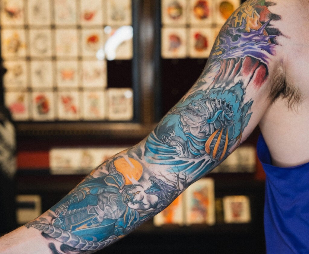 Full-sleeve Final Fantasy summon tattoo with dramatic composition, created at Good Times Ink Osaka.